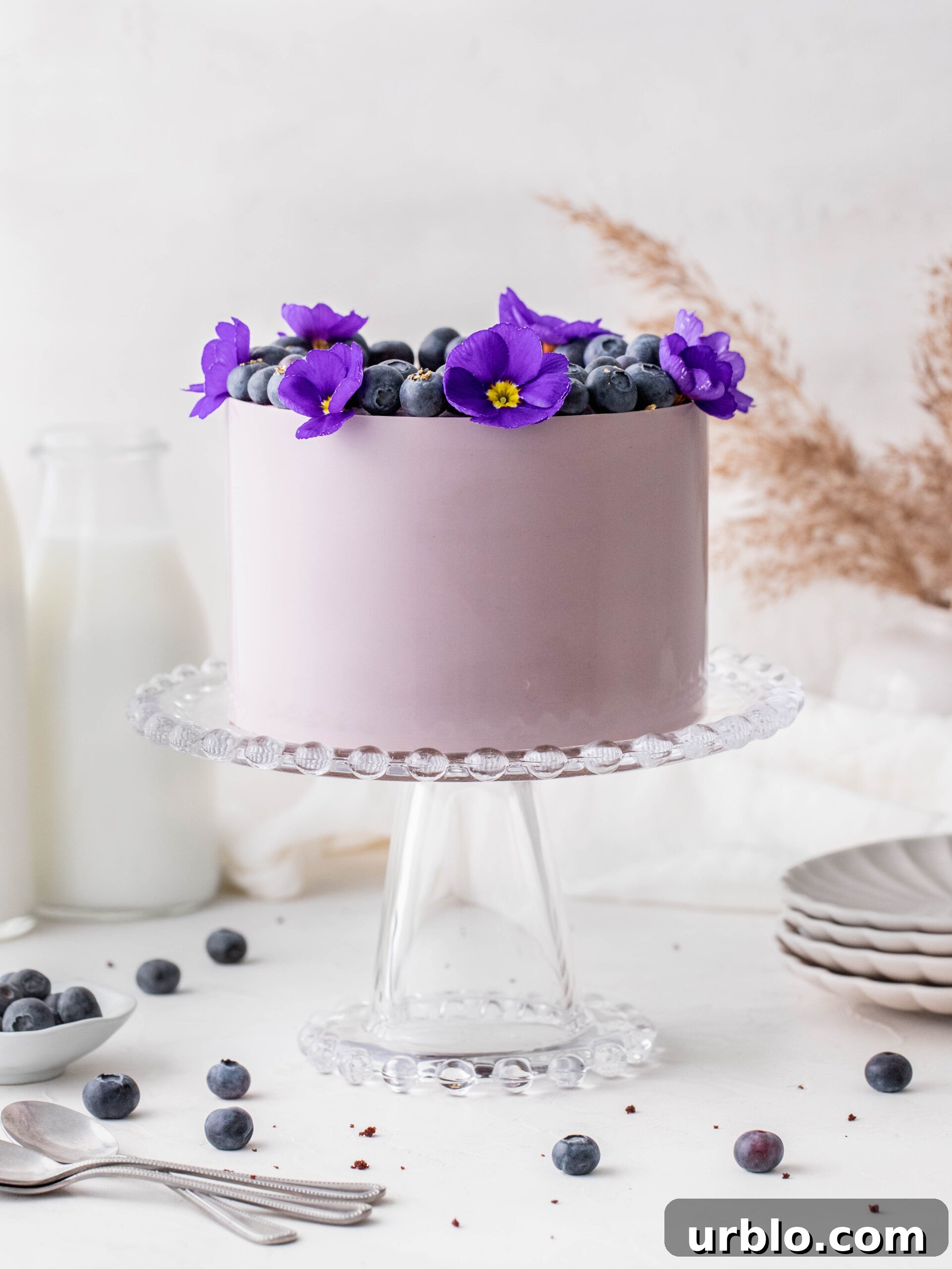 Blueberry Cream Cheese Chocolate Cake on a cake stand.