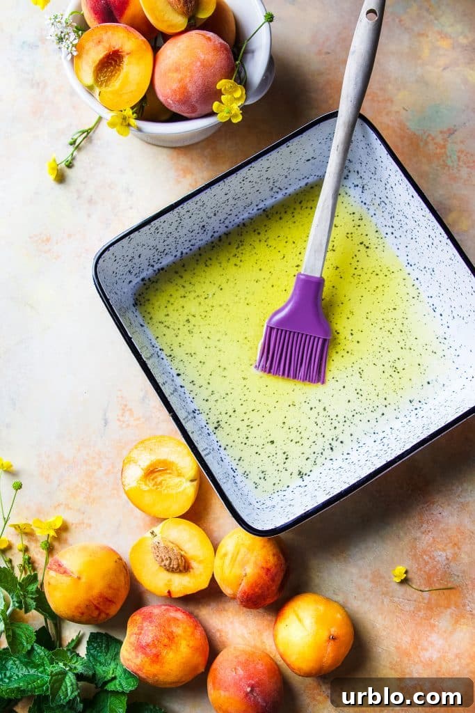 baking dish with butter and a brush. A small bowl with fresh peaches
