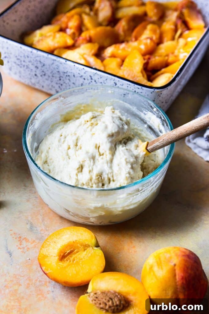 biscuit being made in a glass bowl with spatula. Peach slices in baking dish.