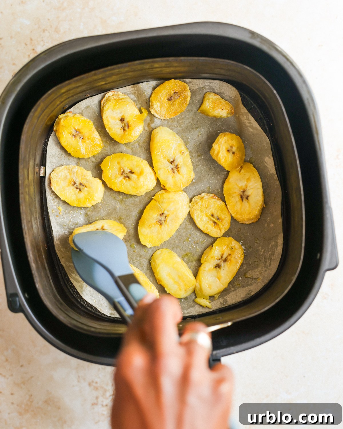overhead flipping the air fried plantains