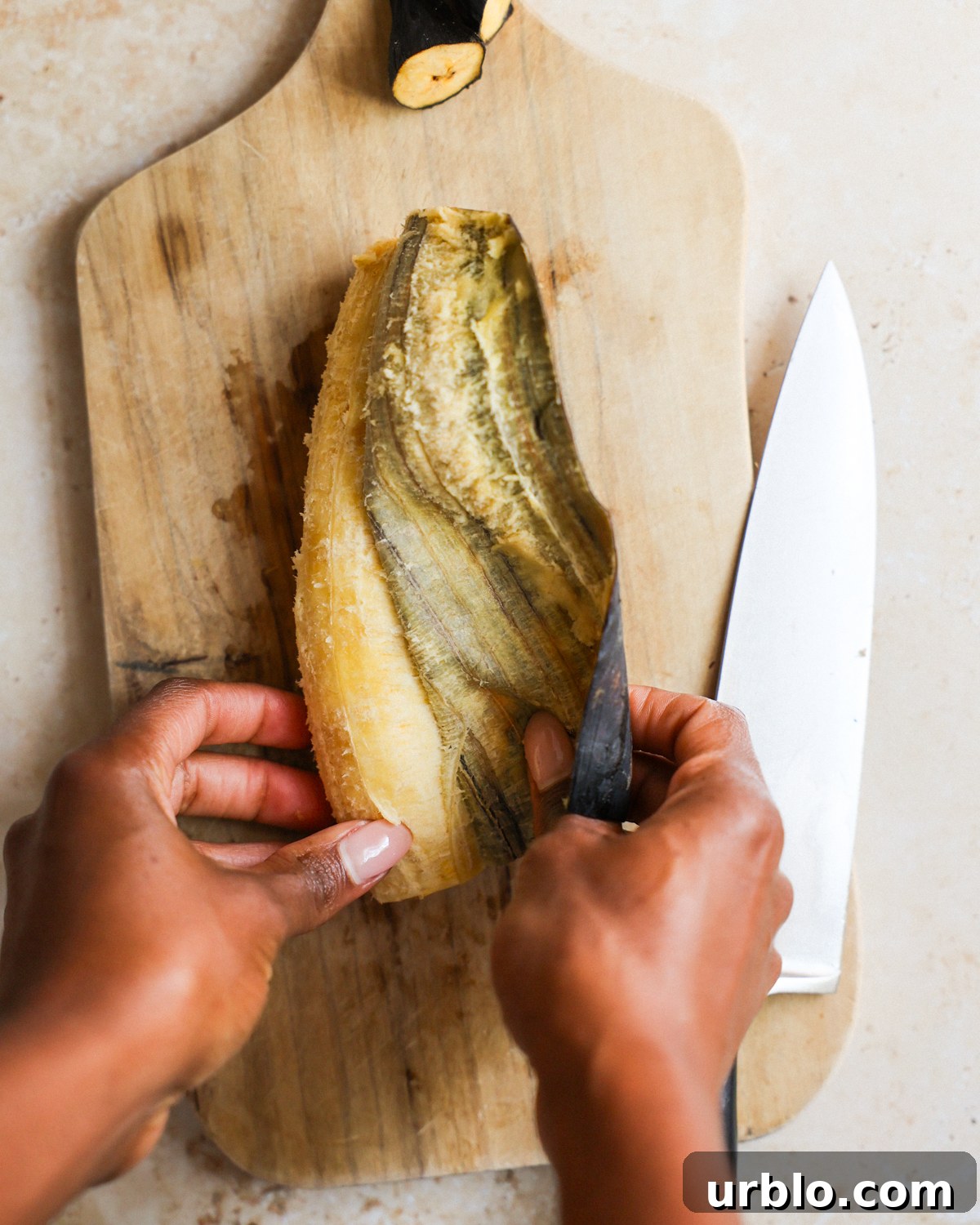 overhead removing peel from the plantain