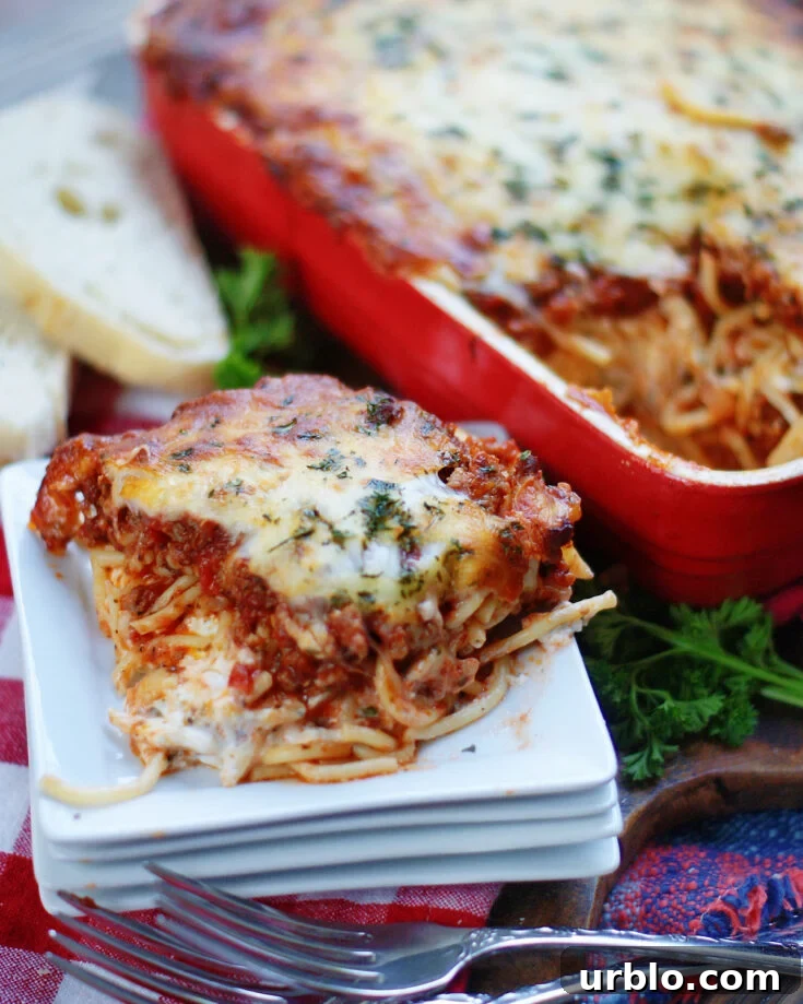 Ultimate Baked Spaghetti Casserole is a layered spaghetti recipe with a creamy cheese center.
