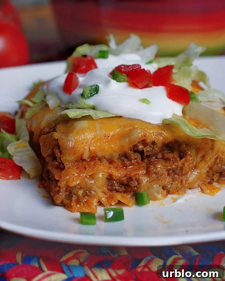 A slice of layered beef enchiladas