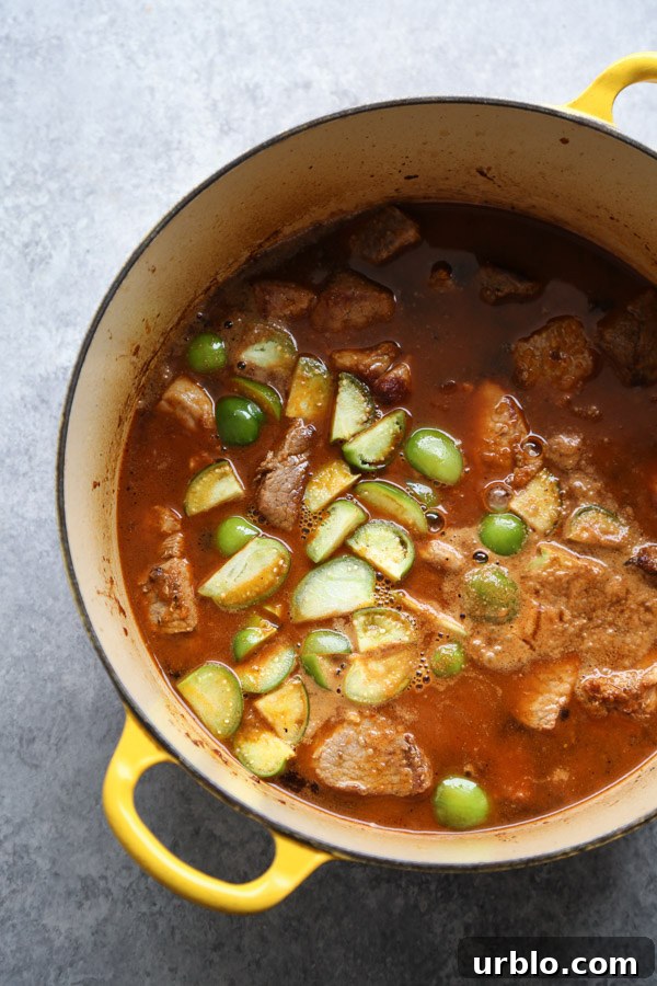pozole rojo recipe in a pot with tomatillos