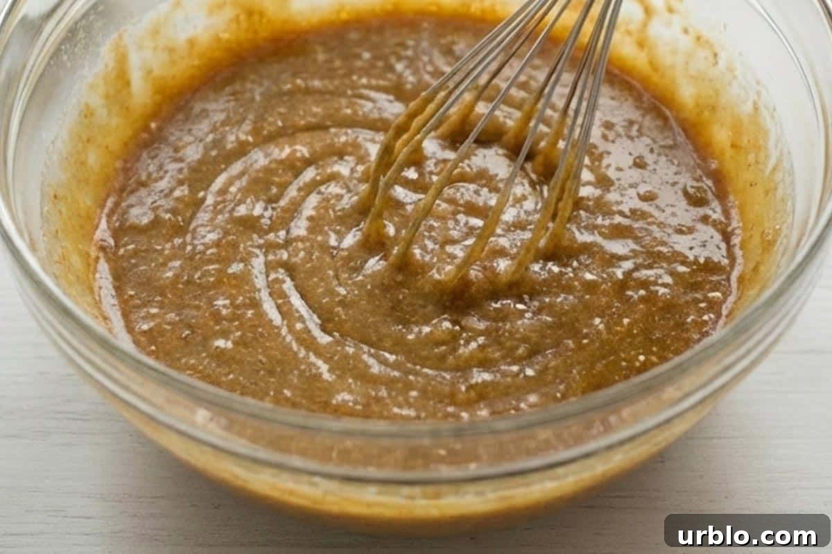 Whisking sugar, butter and apple sauce.