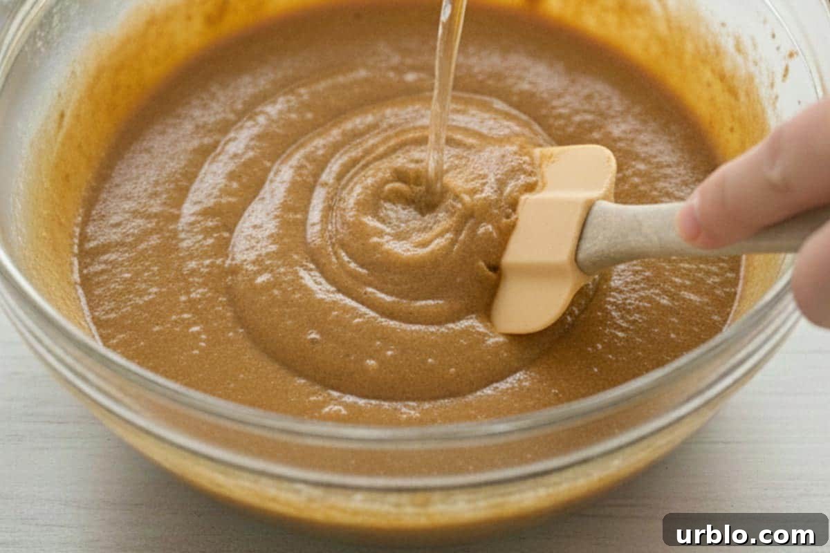Adding water into the batter.