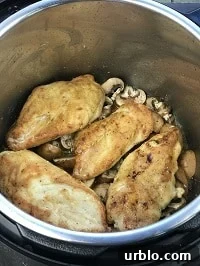 pressure cooking chicken cutlets layered on a bed of mushrooms