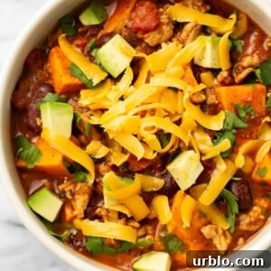 a bowl of sweet potato turkey chili with toppings