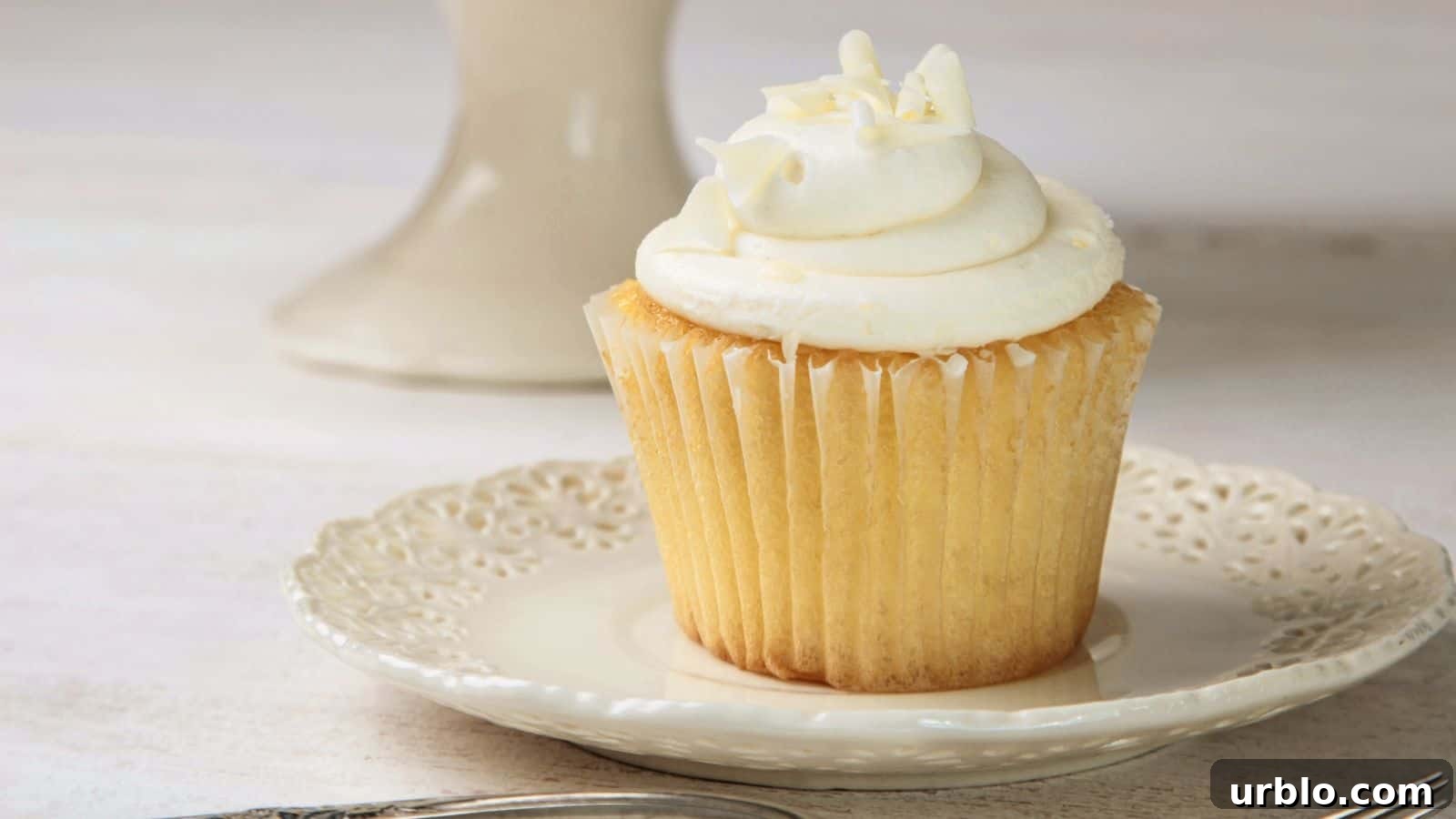 21 Crowd-Pleasing Potluck Recipes That Outshine Store-Bought Dishes 21 Vanilla cupcake with frosting on white china plate.