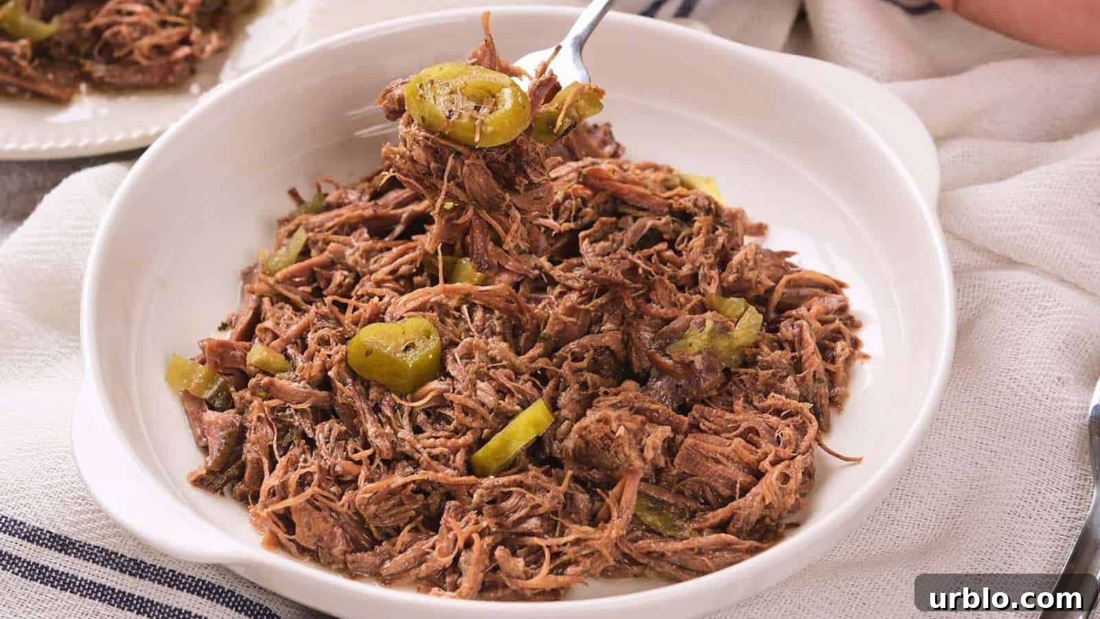 21 Crowd-Pleasing Potluck Recipes That Outshine Store-Bought Dishes 22 A white bowl filled with italian beef and sliced peppers.