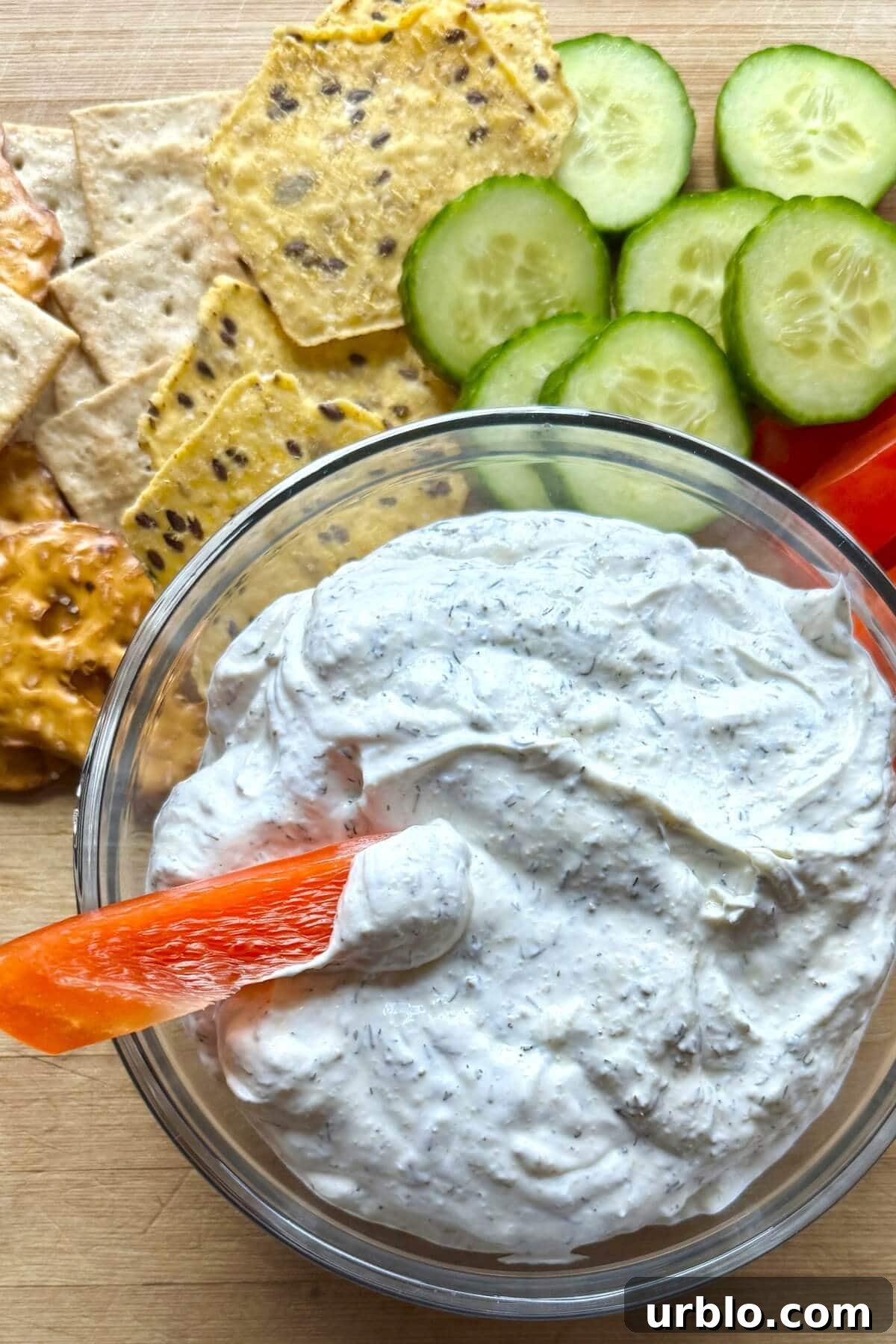 Quick 5-Minute Creamy Dill Dip Recipe for Parties and Snacks 2 A bowl of dill dip with a bell pepper dipped in it.