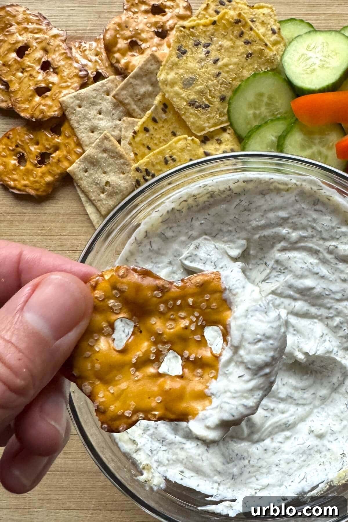 Quick 5-Minute Creamy Dill Dip Recipe for Parties and Snacks 9 A pretzel thin with dip on it.