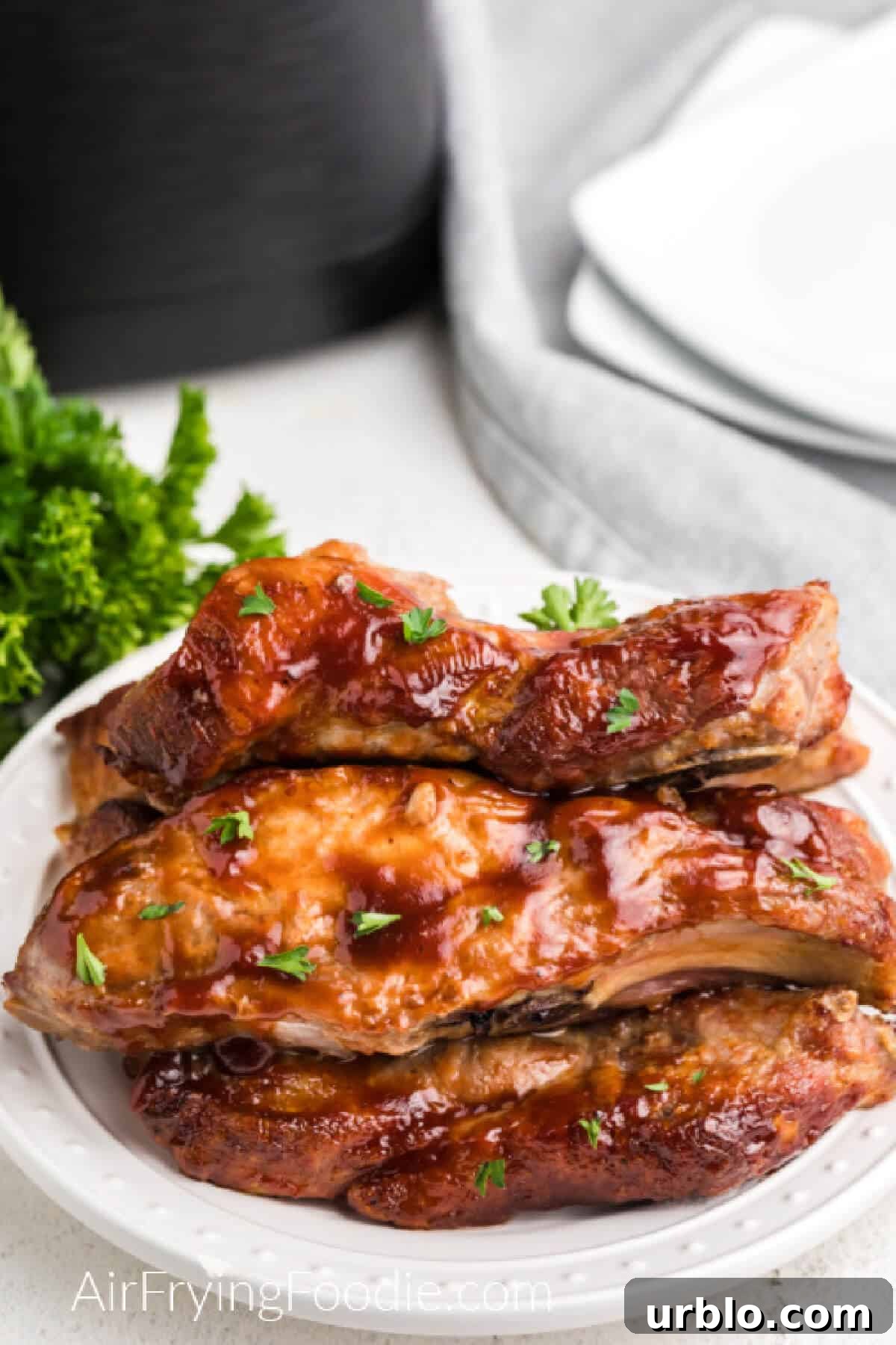 Ribs reheated in air fryer and served on a white plate.