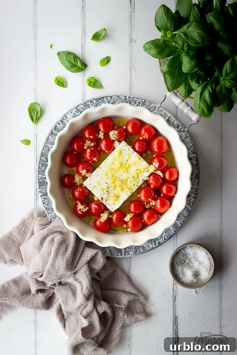 Unbaked feta tomato pasta sauce ingredients in a dish