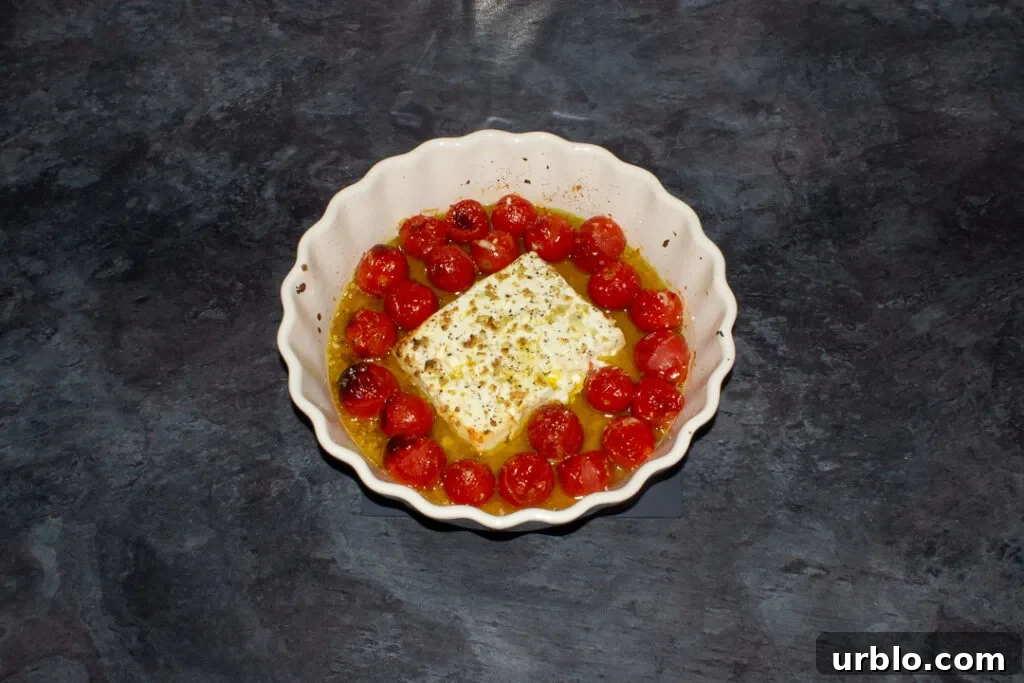 Unmixed baked feta tomato pasta sauce in an ovenproof dish