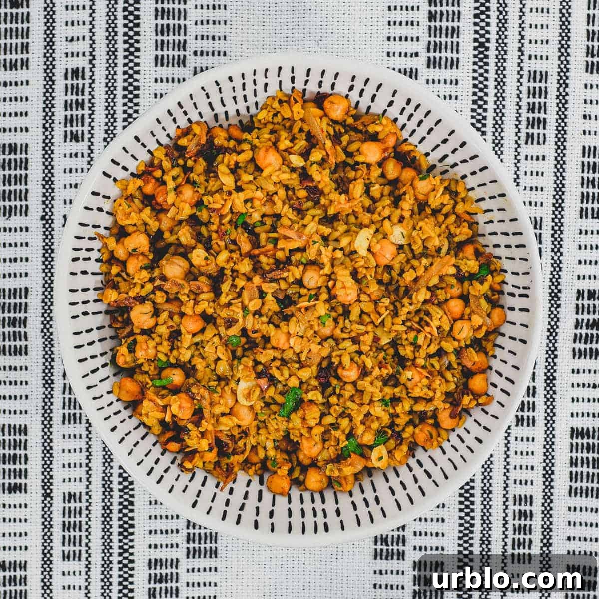 Freekeh cooked with onion and chickpeas in a large serving bowl