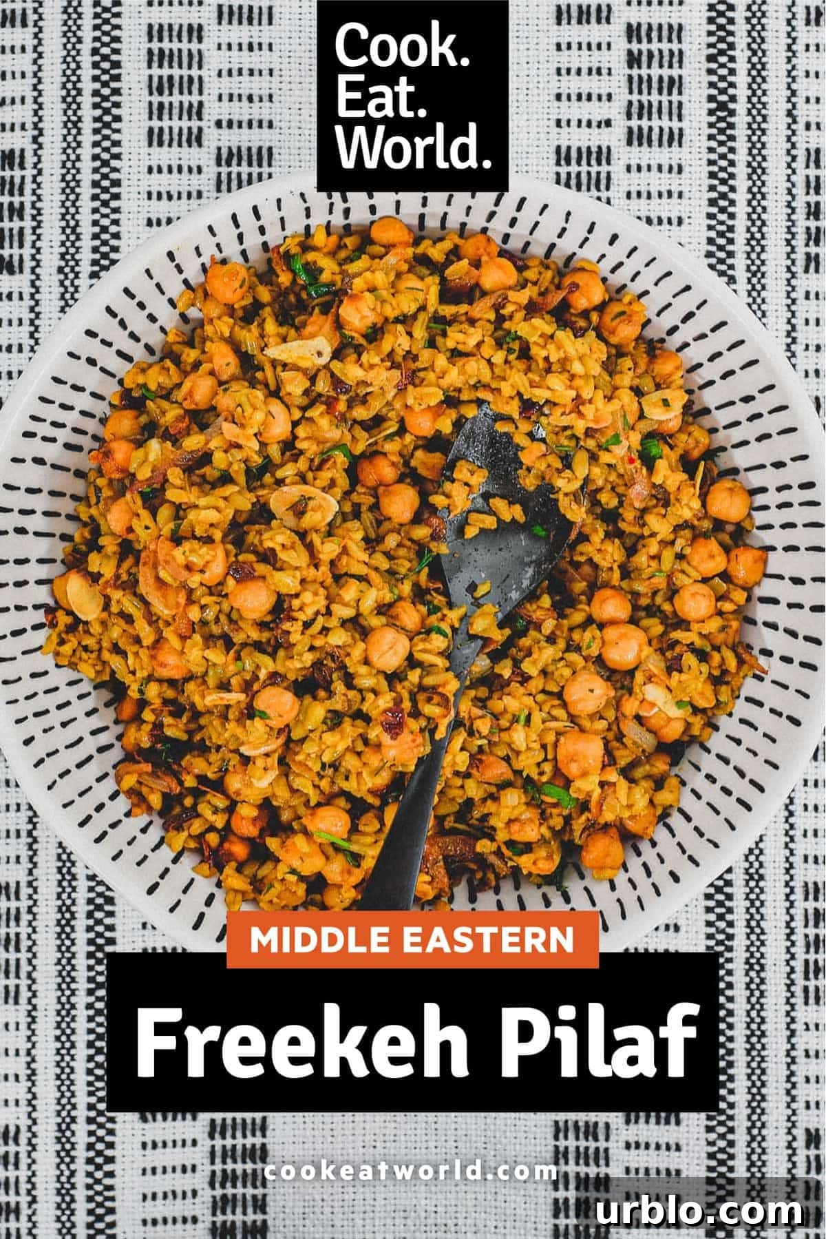 Freekeh cooked with onion and chickpeas in a large serving bowl