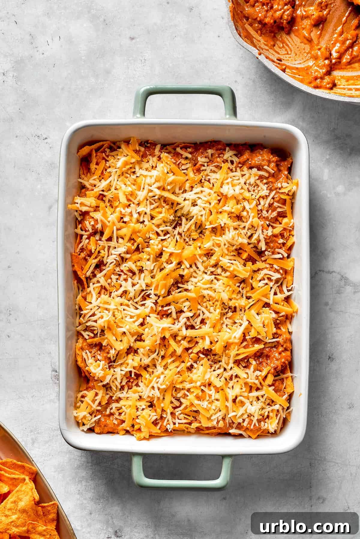 An assembled Dorito casserole in a casserole dish.