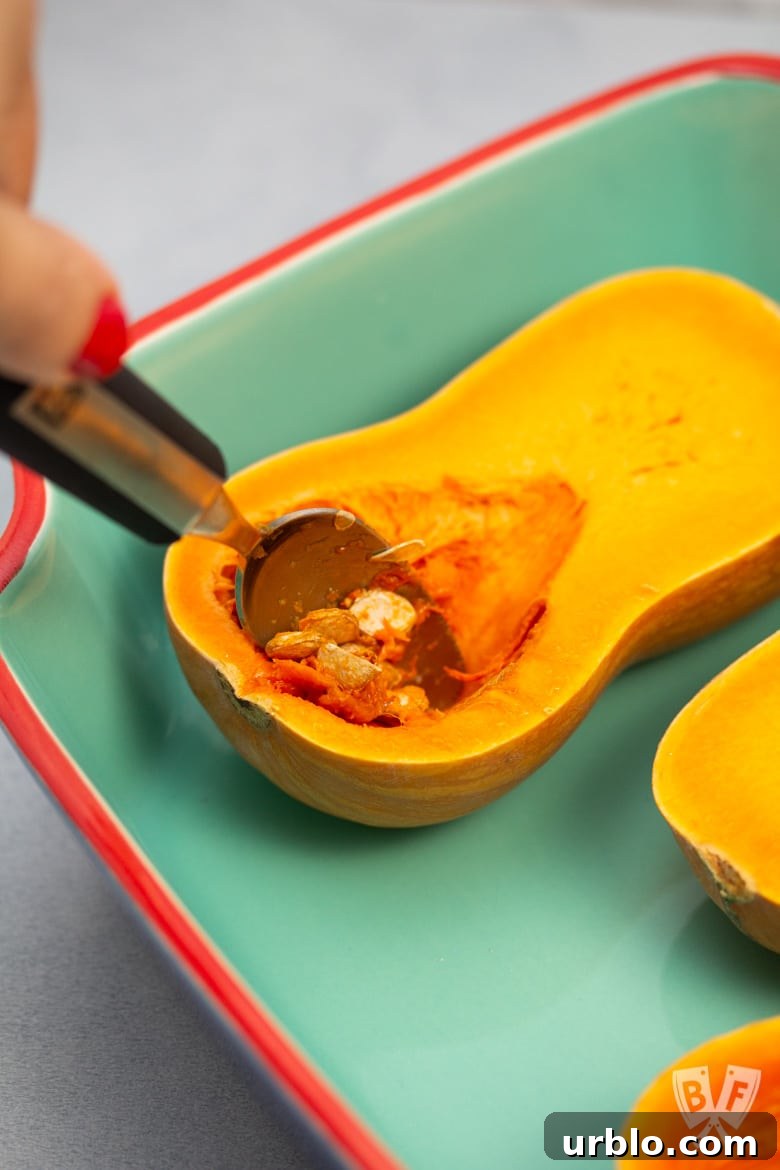 Scooping seeds out of a honeynut squash
