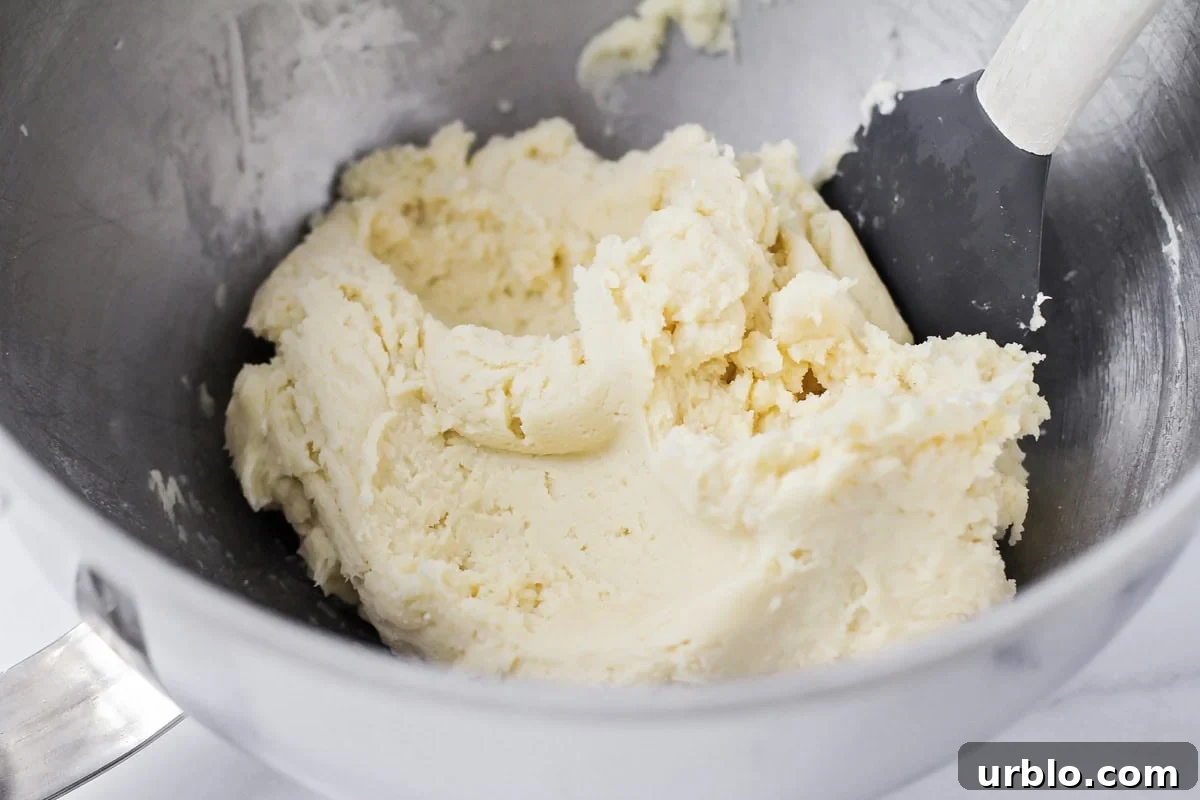 Cookie batter in a metal bowl.