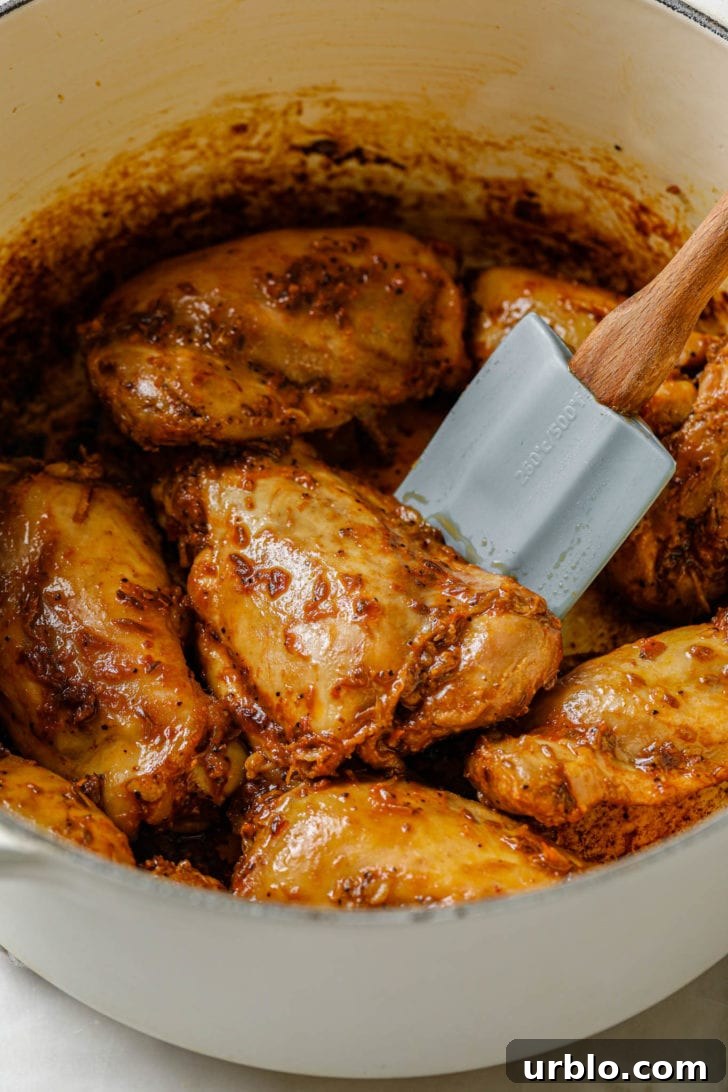 Tossing chicken in ketchup.