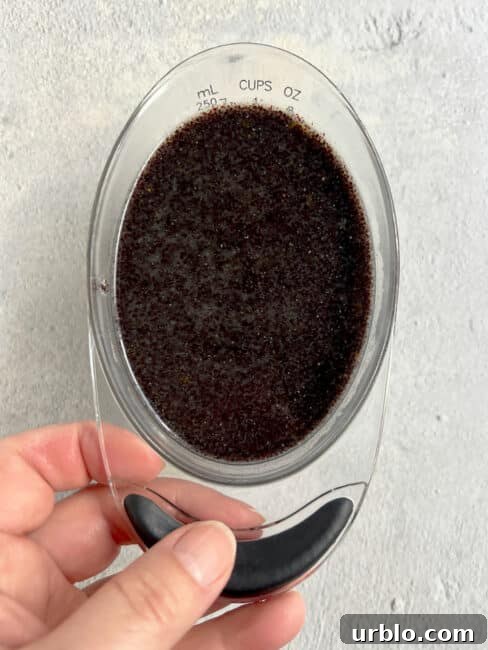 poppy seed filling in a 1-cup measuring cup.
