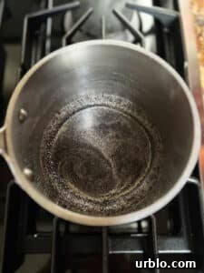 Poppy seed filling starting to boil in pot.