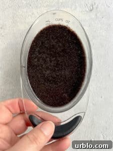 poppy seed filling in a 1-cup measuring cup.