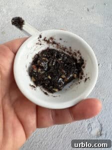 Walnuts mixed into a small amount of the filling in a small white bowl.
