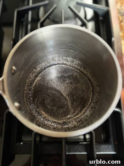 Poppy seed filling starting to boil in pot.