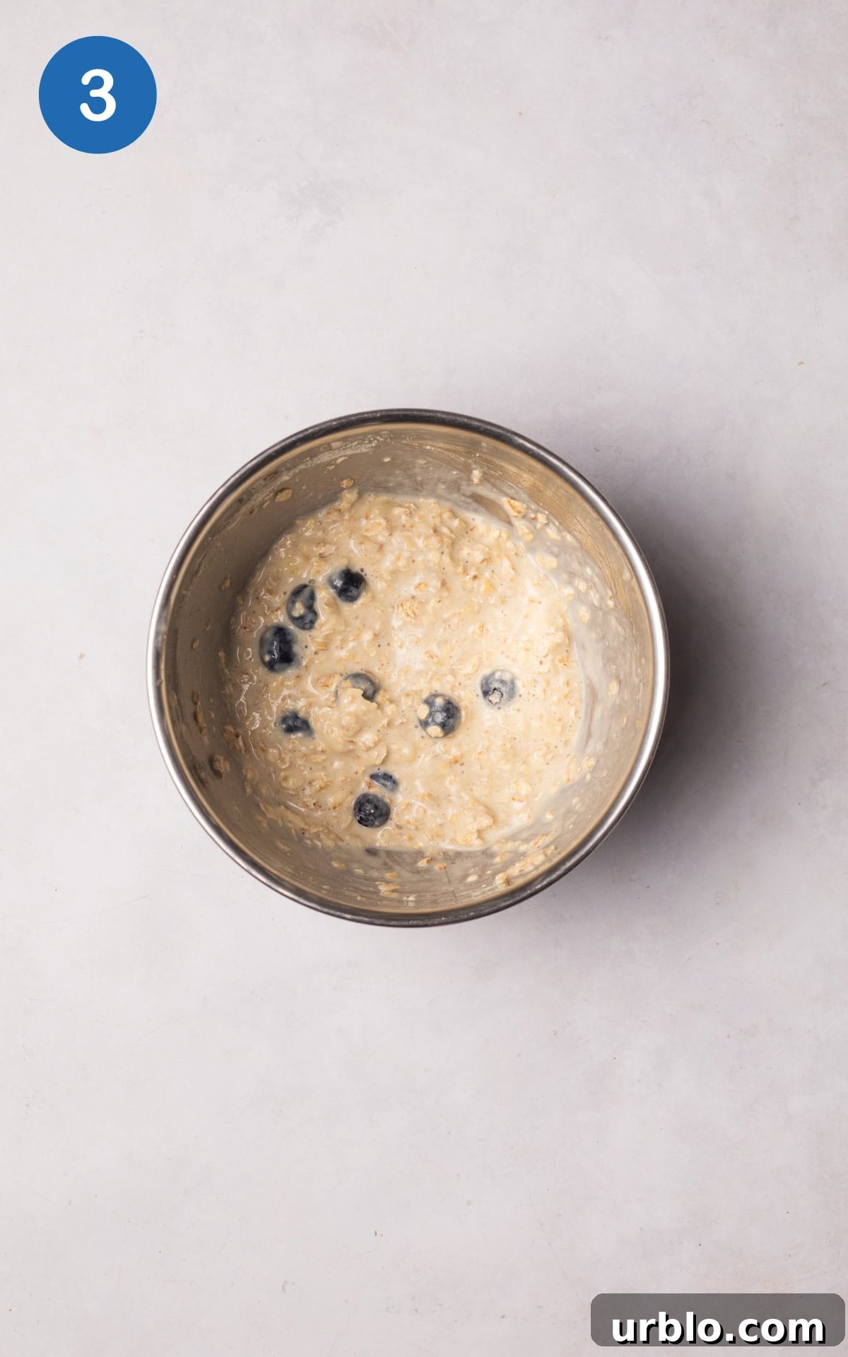 Blueberries added to the mixture in a bowl.