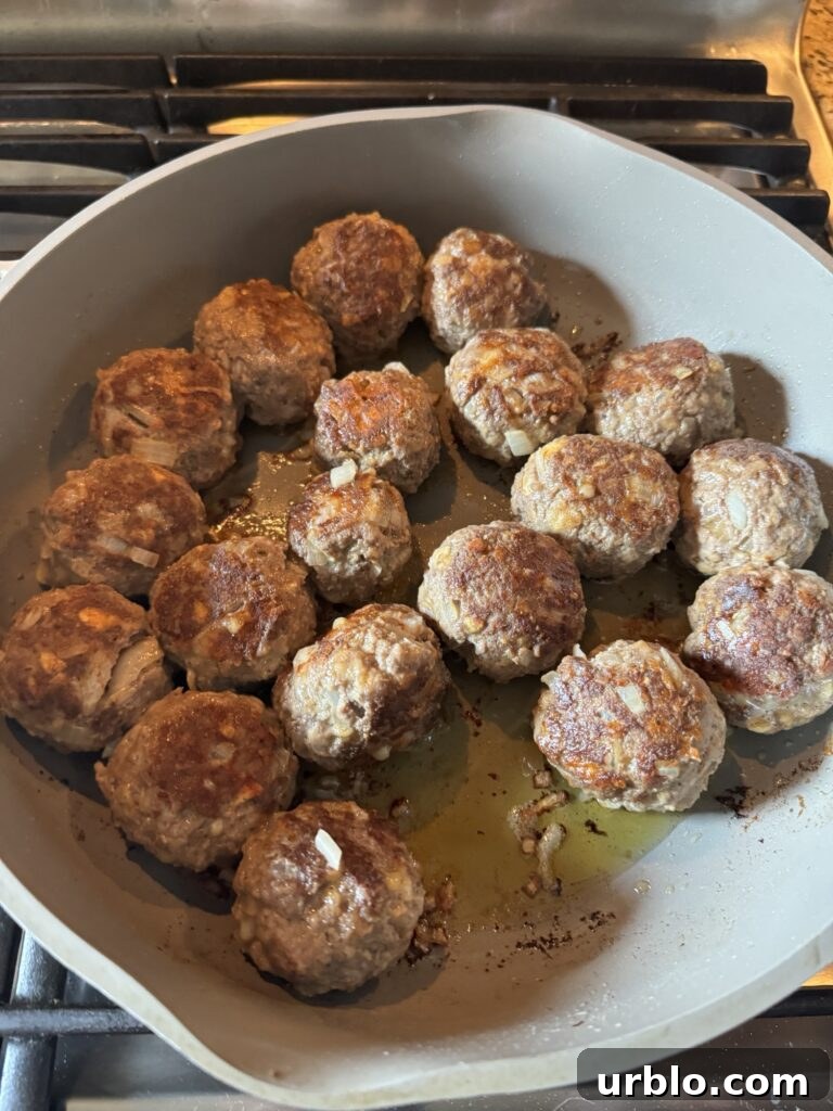 Meatballs cooking in the pan.