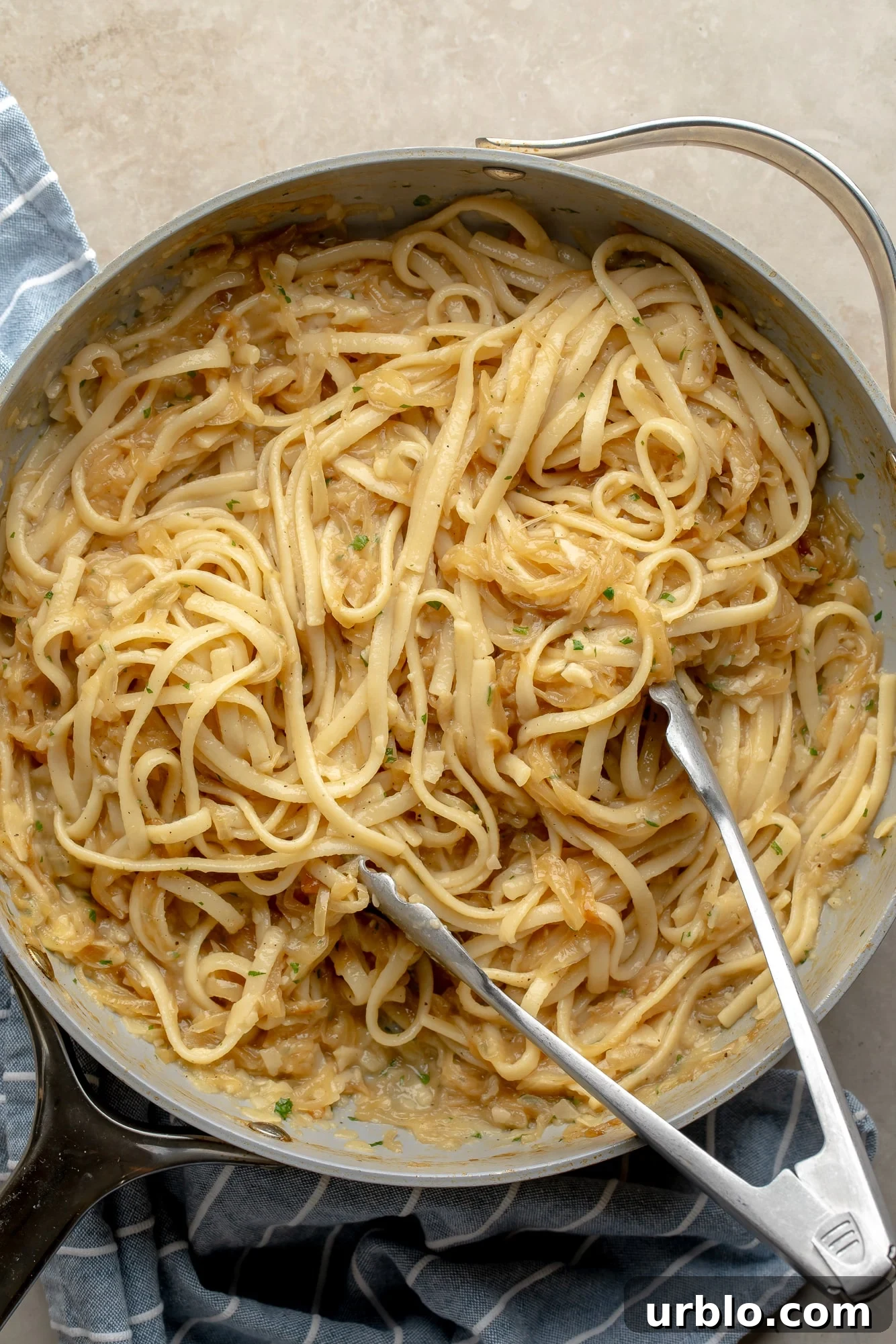 overhead view of a skillet full of vegan caramelized onion pasta.