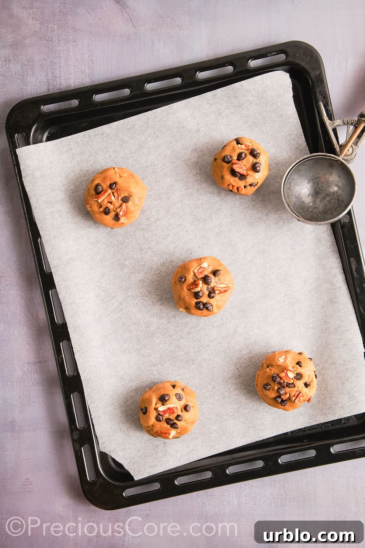 Cookie dough scooped onto a prepared baking sheet.