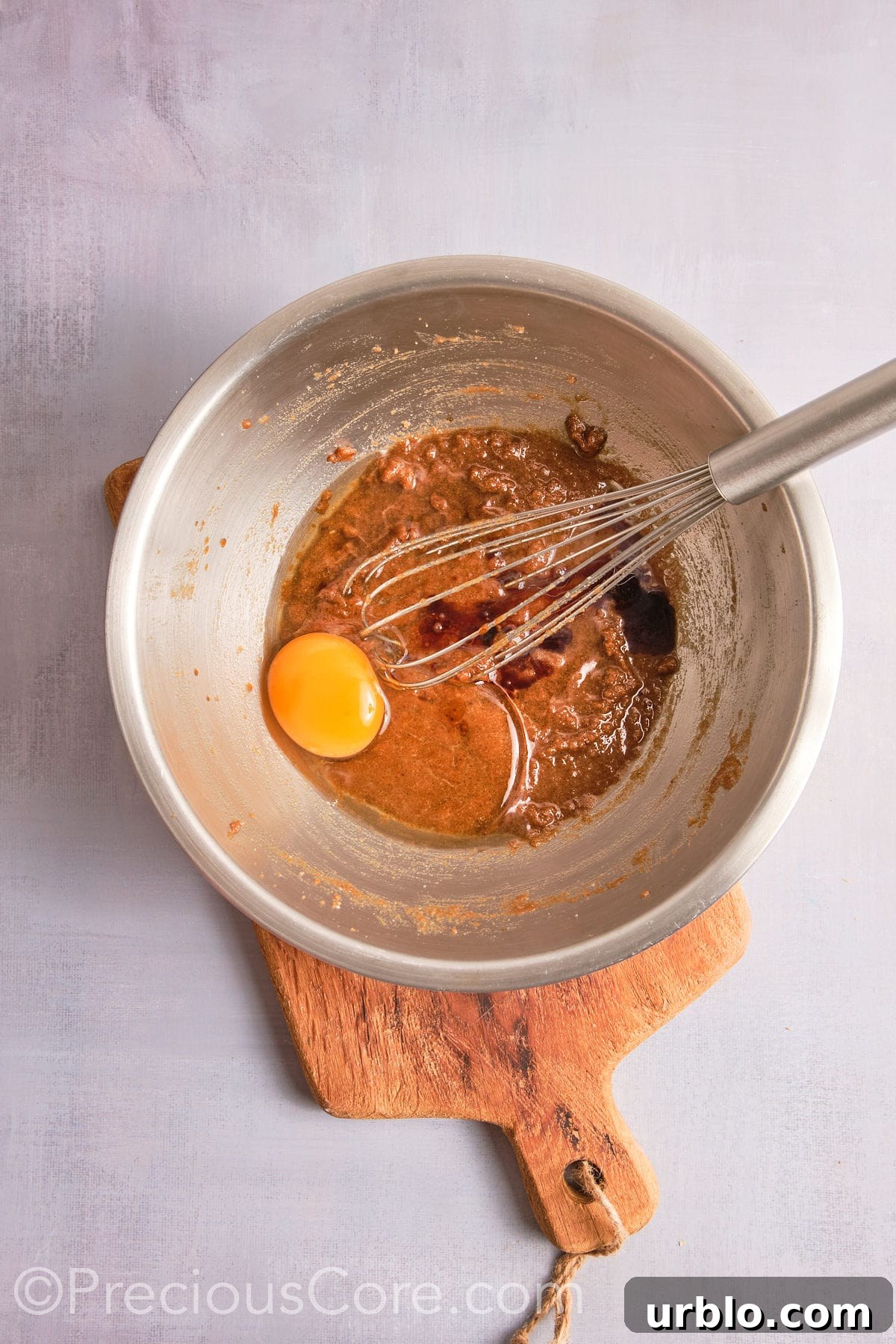 Adding egg and vanilla to the brown butter mixture.