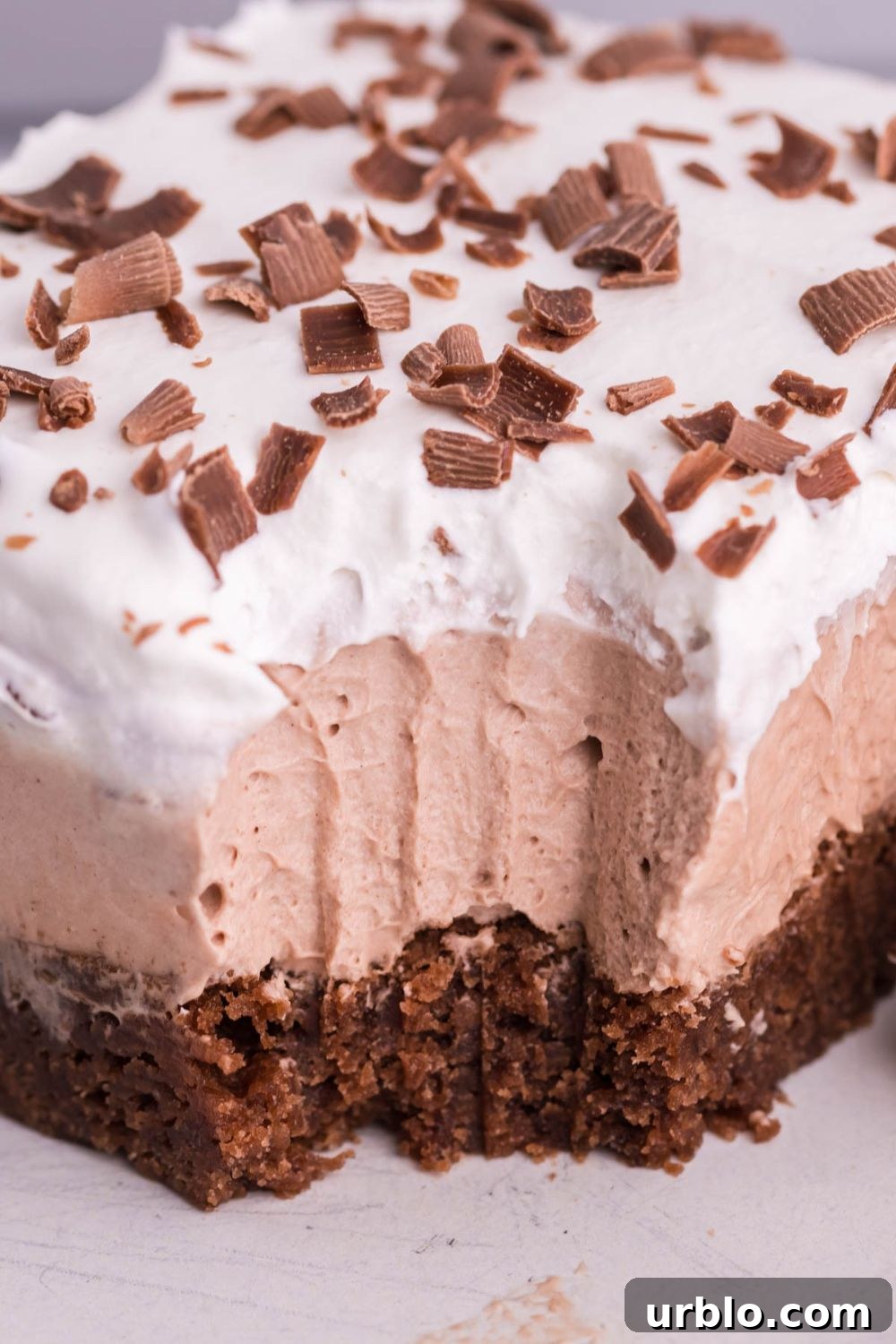 French silk pie brownie with bite taken out of it sitting on plate
