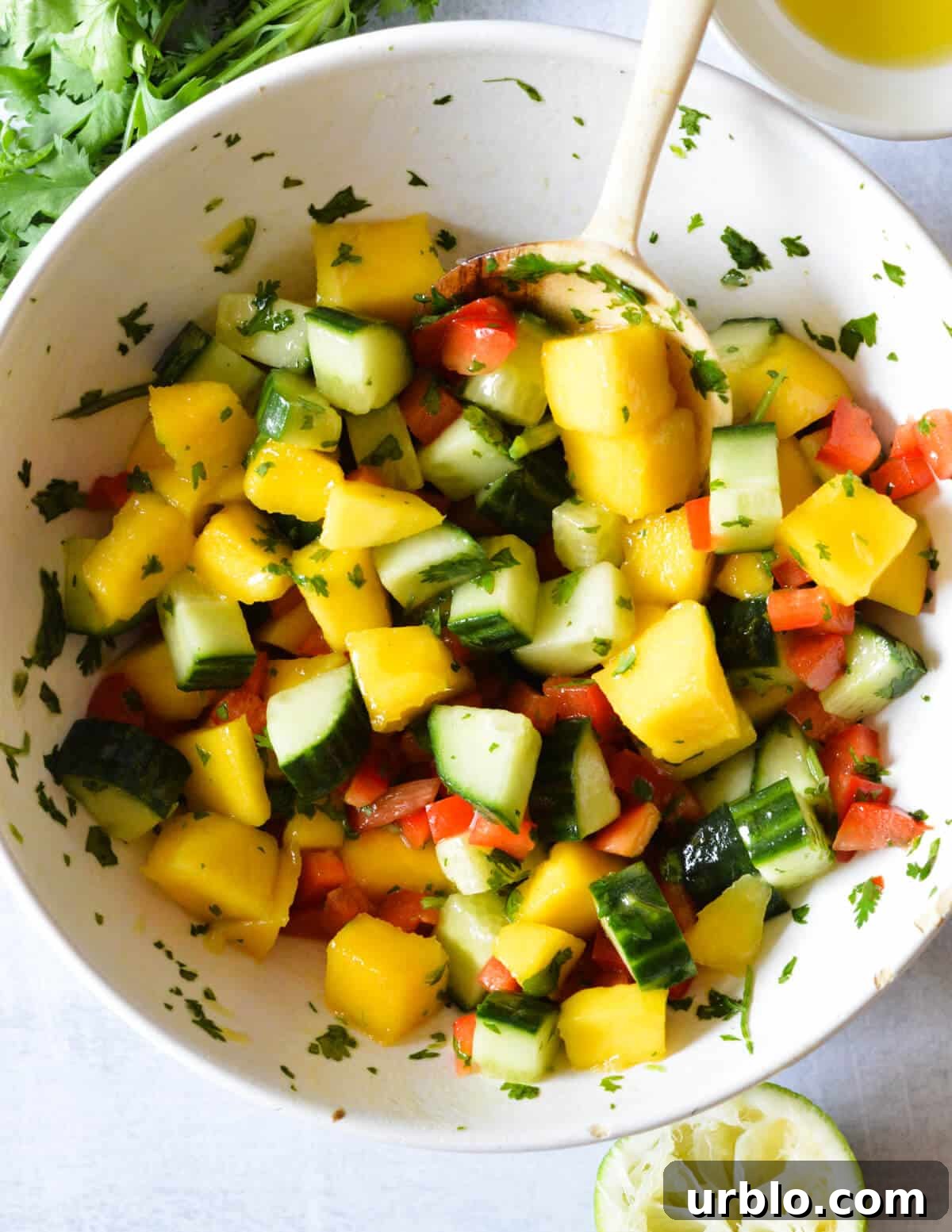 a bowl of cucumber mango salad.