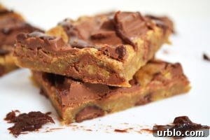 Whittakers Toffee Milk Chocolate Bars. Soft, dense and chewy toffee slice with chocolate chips and Whittakers Toffee Milk Chocolate pieces throughout. Topped with more Whittakers Toffee Milk Chocolate pieces and melted chocolate! Recipe on Lights, Camera, BAKE! #WhittakersToffeeMilkBlock #toffeebars #chocolatetoffeeslice #softtoffeebars #milkchocolatebars