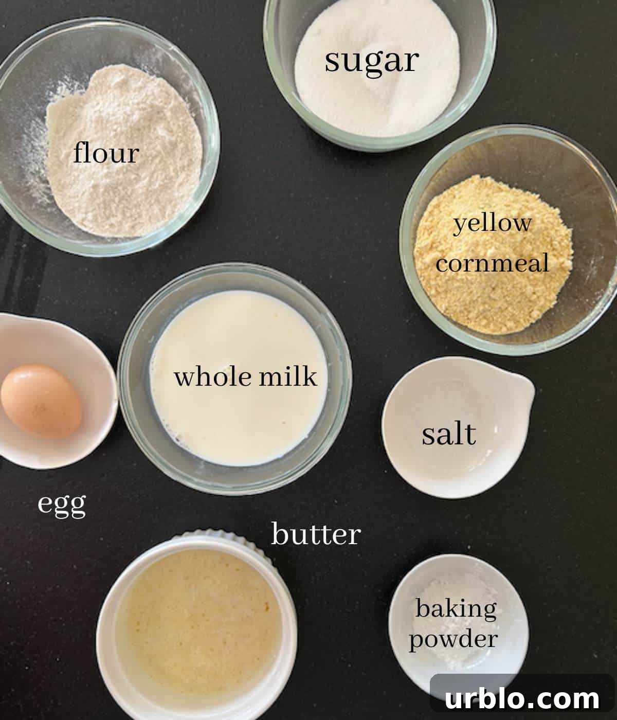 Moist Fluffy Cornbread Recipe Without Buttermilk 3 Cornbread ingredients on black countertop.