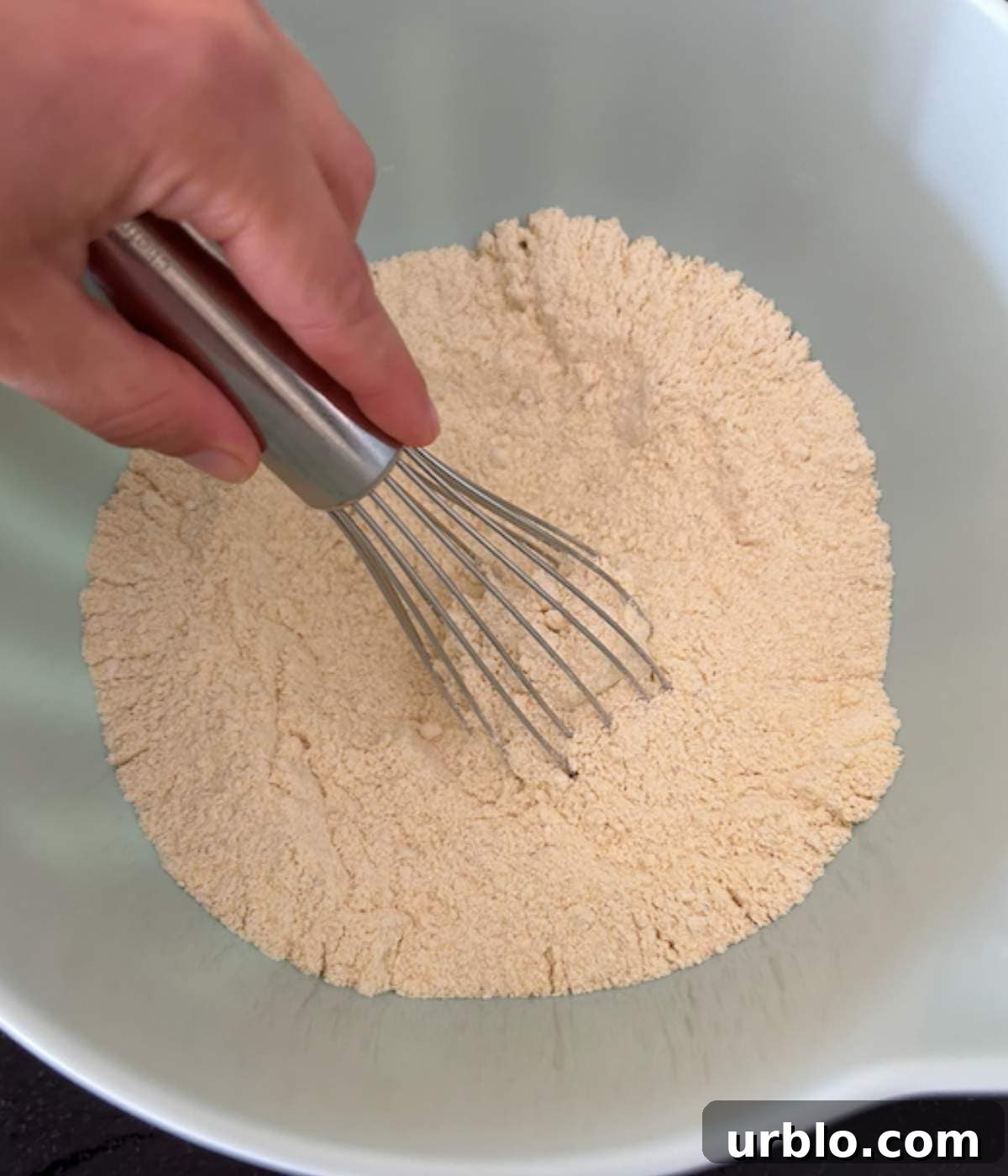 Moist Fluffy Cornbread Recipe Without Buttermilk 4 Hand whisking dry ingredients for cornbread.