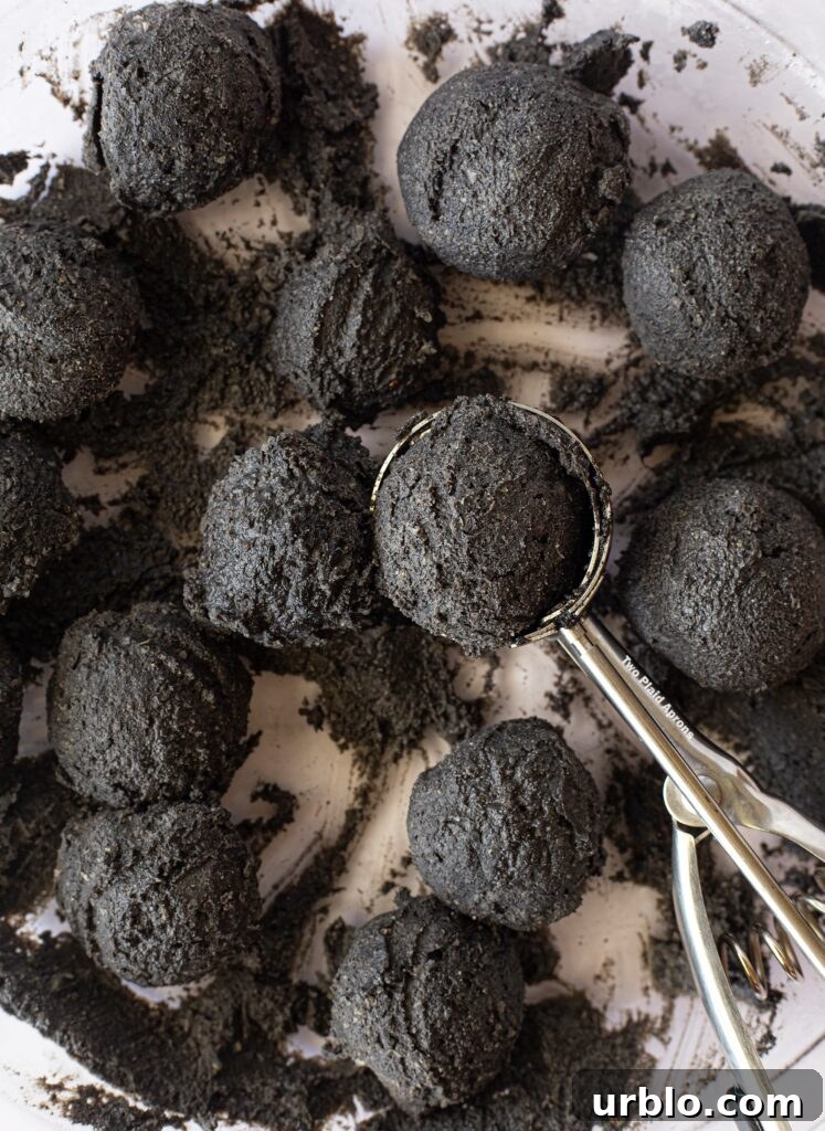 Black sesame filling portioned into balls with a cookie scoop.