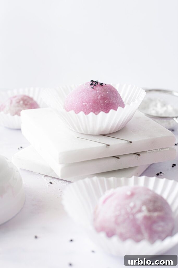Ube mochi with black sesame filling in cupcake liners.