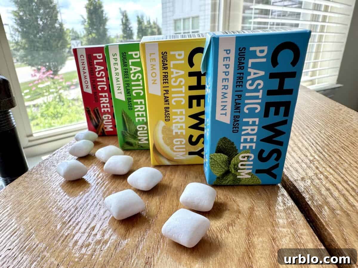 Four boxes of Chewsy's different flavored plastic-free gums, with a few pieces of gum on the table next to them.