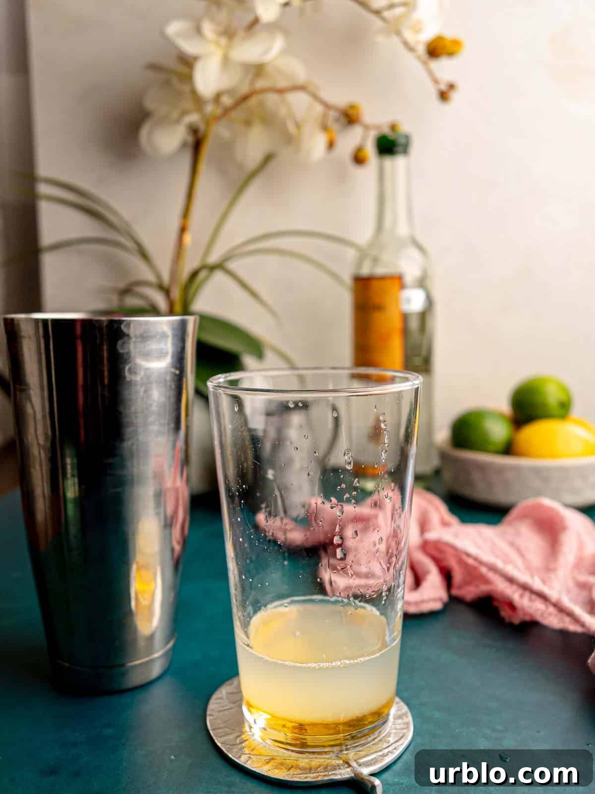 Mezcal sour in a mixing glass.