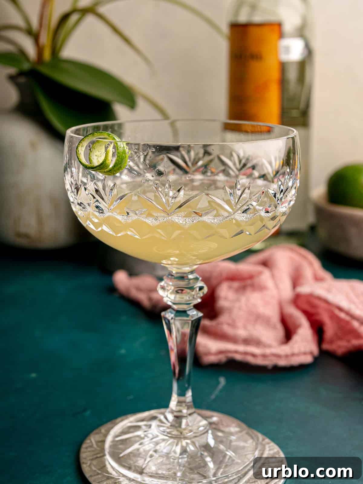 Mezcal drink on silver coaster.