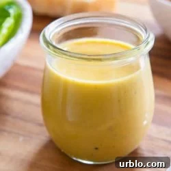 Caesar Dressing In Glass Jar with Parmesan Hunk and Croutons on Board