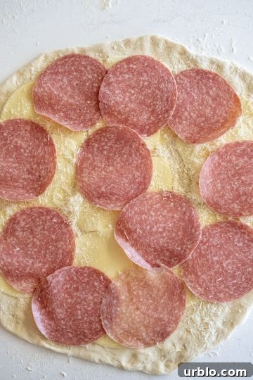 Layer of salami added to the dough