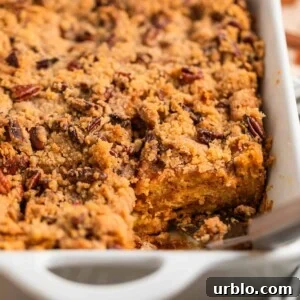 Casserole dish with baked brioche French toast casserole topped with pecan streusel.