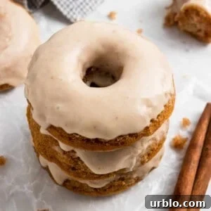 Apple donuts with apple cider glaze stacked.
