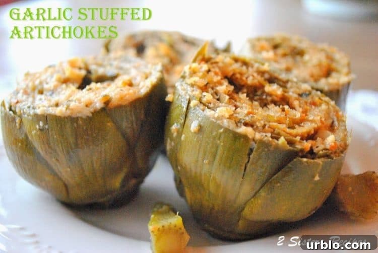 four garlic stuffed artichokes on a plate